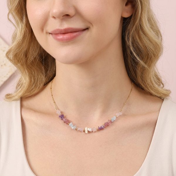 Handmade jewelry featuring natural stones such as rose quartz and amethyst chips, in a bohemian style.
